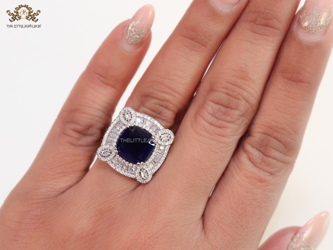 Open Sapphire blue platinum ring with heavy cz border