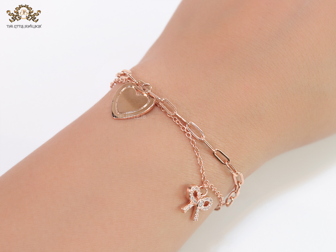Dual chain rose gold bracelet with heart and bow