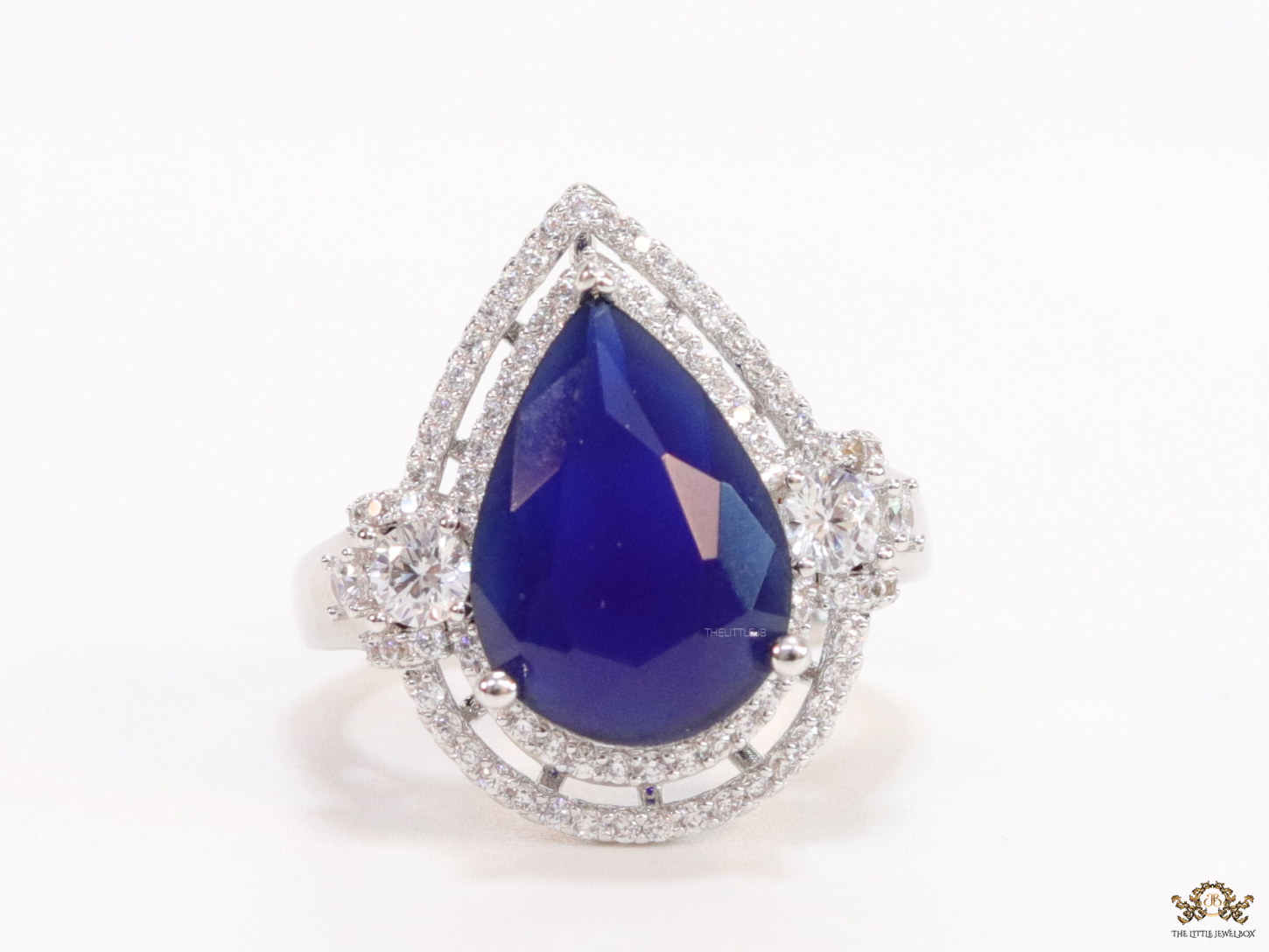 Platinum plated cz open ring with sapphire blue drop stone - Image 4