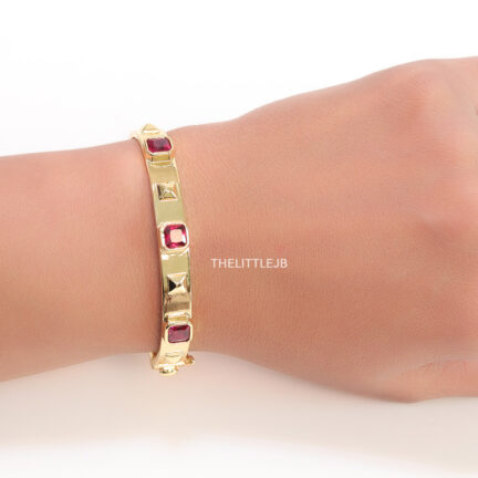 b1 Band style bracelet in gold plating with gold plated details and ruby red colour stones