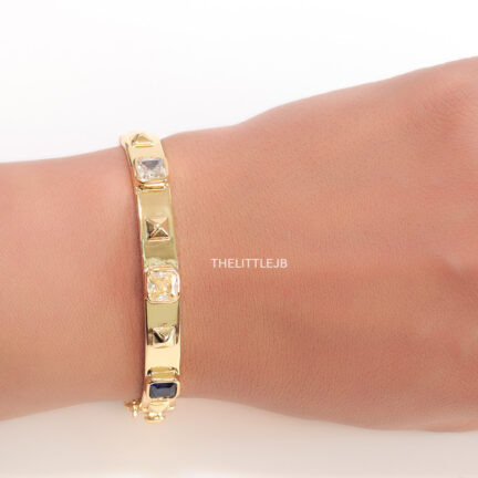 b2 Band style bracelet in gold plating with gold plated details and multi colour stones