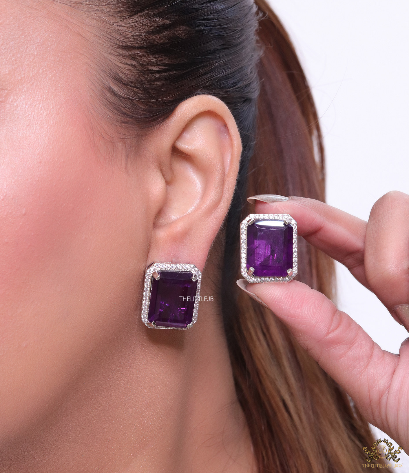 Platinum plated studs with purple doublet stone and white cubic zirconia stones lining