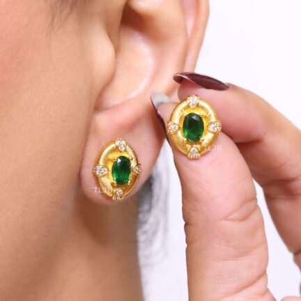 Gold studs with emerald centre and cz