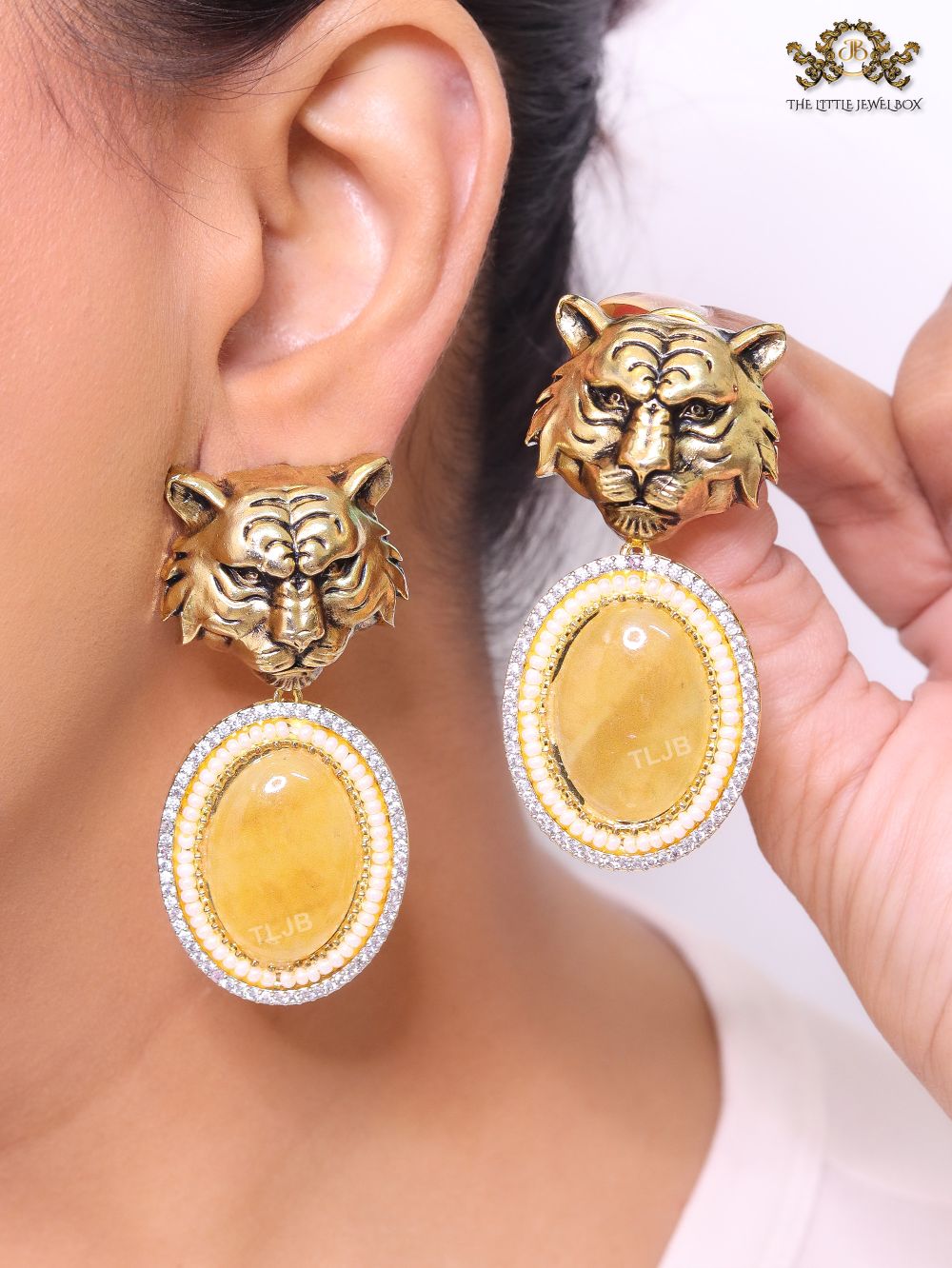 Antique tiger face with yellow stone.