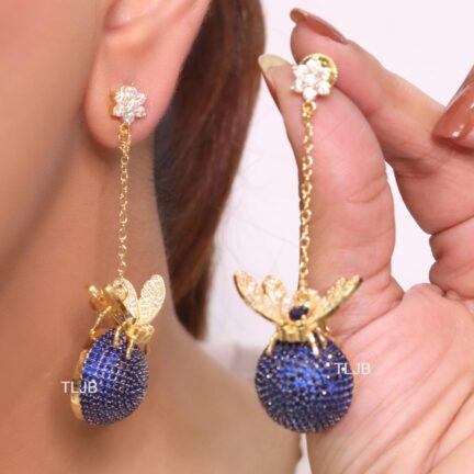 Butterfly motif and half ball danglers in blue cz