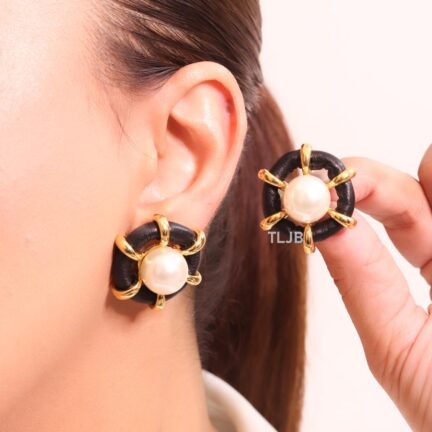 Pearl and black leather statement studs