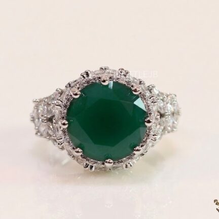 image_1775652422440 CZ laden platinum ring with green stone centre